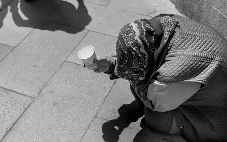 a poor woman begging on a street in Venice