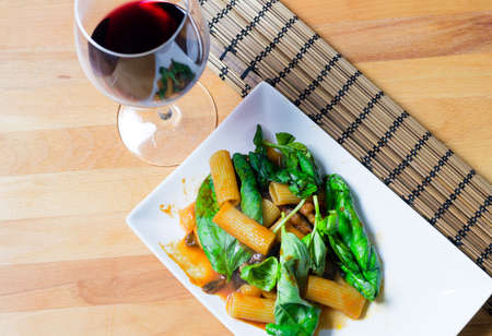 Pasta alla norma and red wineの写真素材