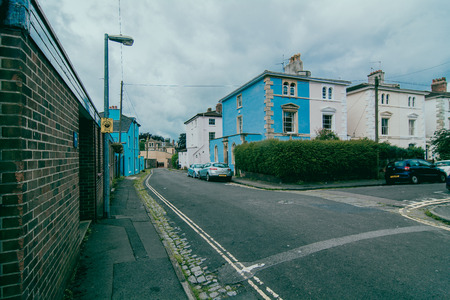 suburban street with cloudy skyの写真素材