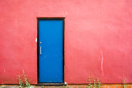 blue door on a red wall