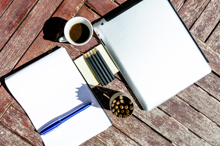 Organization of work: coffee, tablet, computer, notebookの写真素材
