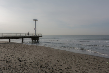 pier and fisherman at seaの写真素材