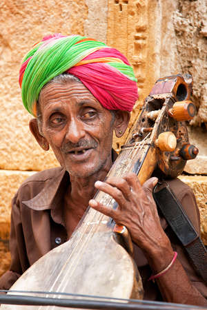 JAISALMER, INDIA - AUGUST 12   Unidentified musician playing Sitar on street  The Sitar is a plucked stringed instrument widely used in Indian classical music のeditorial素材