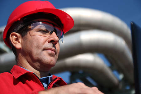  Engineer With Red Hard Hat and Pipelinesの写真素材