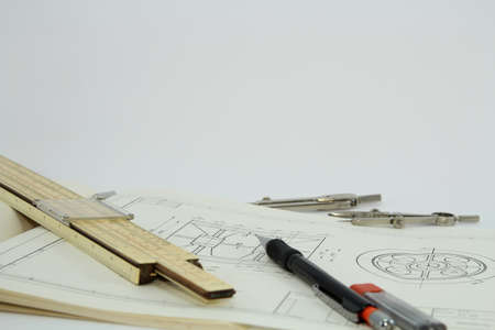 Technical drawings and slide rule on white background の写真素材