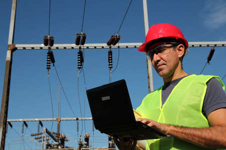 Engineer with personal protective equipment typing on the computer keyboard の写真素材