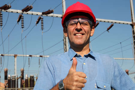 Engineer at electrical substation showing thumbs up の写真素材