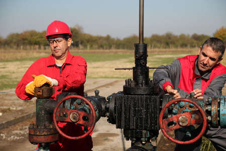 Two oil and gas engineers working on oil rig equipment の写真素材