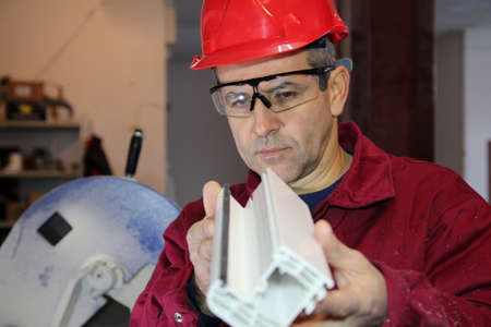 Engineer controlling plastic extrusion profile for window の写真素材