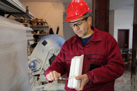 Engineer measuring plastic extrusion profile for window whit vernier caliper の写真素材