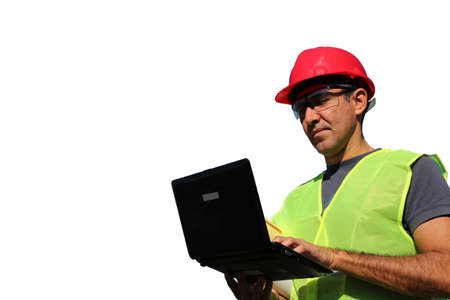 Engineer with personal protective equipment typing on the computer keyboard isolated over a white background の写真素材