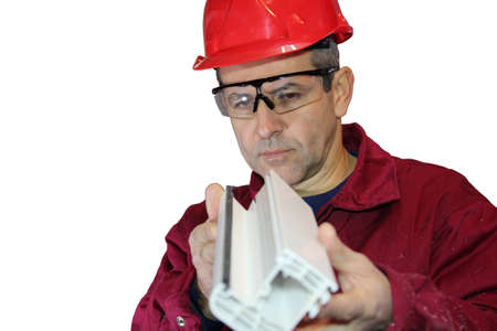 Industrial engineer with red hard hat checking the quality of product  isolated over a white backgroundの写真素材