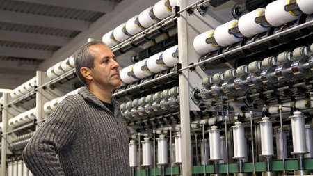 Industrial Engineer Closely Monitor Every Step of the Yarn Manufacturing Process.の写真素材