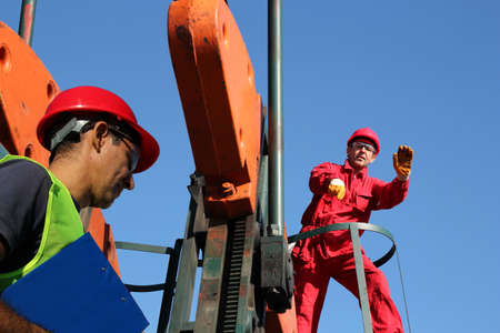 Oil workers at work in the oil fieldの写真素材