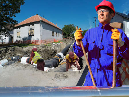 Group of construction workers at work during reconstruction of city heating systemの写真素材