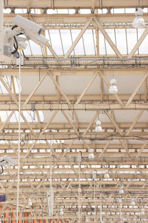 Metal structure of a white ceiling seen from below in the interior