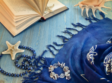 open book, pareos and starfish on blue wooden floorの写真素材