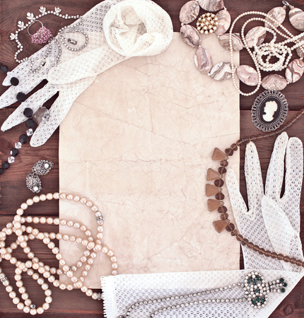 Frame with old women's jewelry and lacy white glovesの写真素材