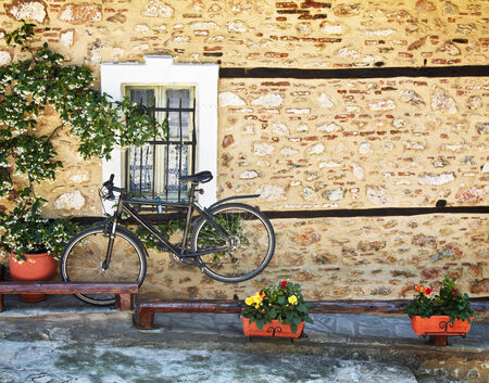 Black  bicycle against old house wallの写真素材