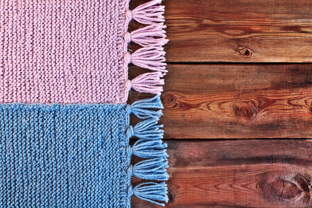 Beautiful knitted scarf on wooden textureの写真素材