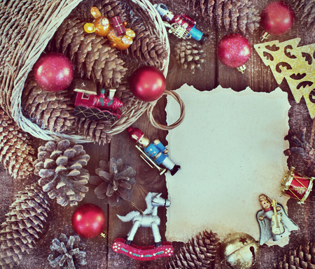 Christmas frame with Christmas decorations, pine cones and basketの写真素材