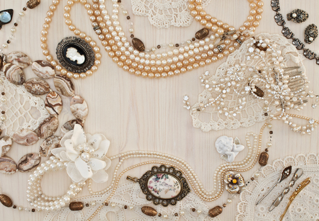 Beautiful female jewelry and trinkets on a light wooden backgroundの写真素材