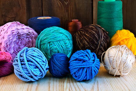 colored thread and yarn on the wooden table