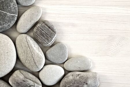 Smooth pebbles on an old wooden background. Place for your textの写真素材