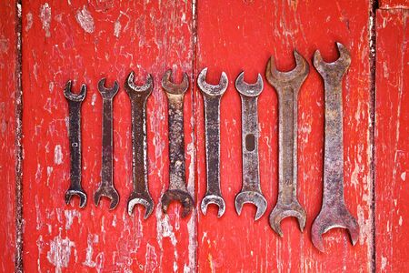 Old wrenches on the floor stained with red paint. Retro conceptの写真素材