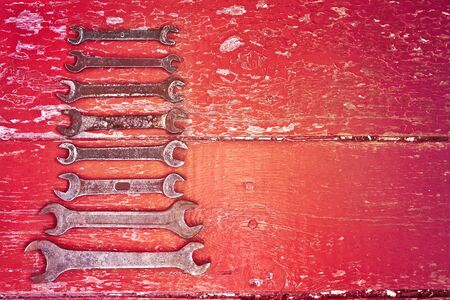 Old wrenches on the floor stained with red paint. Retro conceptの写真素材