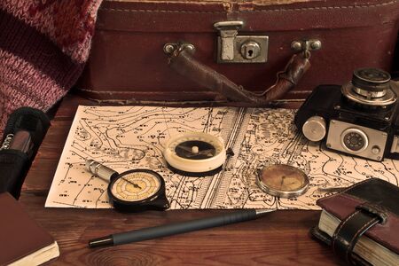 Vintage tools of a traveler, compass,  camera, suitcase and mapの写真素材