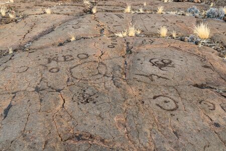 Petroglyphs in Waikoloa Field, on the King's Trail ("Mamalahoa"), near Kona on the Big Island of Hawaii. Carved into volcanic rock, the earliest of these carvings are more than a century old.の写真素材