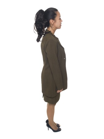 Isolated full length studio shot of a businesswoman facing sideways.の写真素材