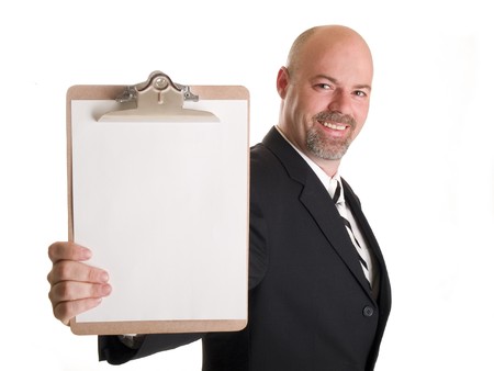 Stock photo of a well dressed businessman holding a clipboard.の写真素材