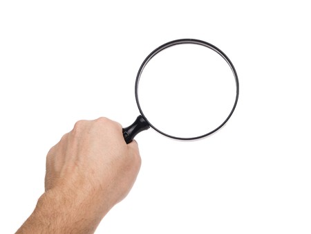 Magnifying Glass held in hand, shot in studio on a white background.の写真素材