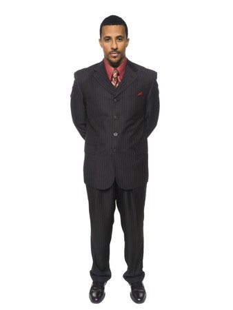 Isolated full length studio shot of a confident businessman standing and looking at the camera.の写真素材