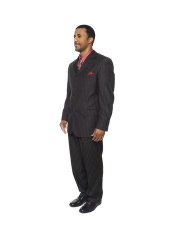 Isolated full length studio shot of a businessman facing slightly away from the camera.の写真素材