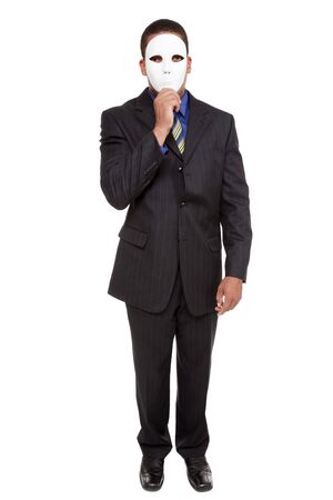 Isolated studio shot of a businessman holding a blank costume mask up to his face and looking at the camera.の写真素材