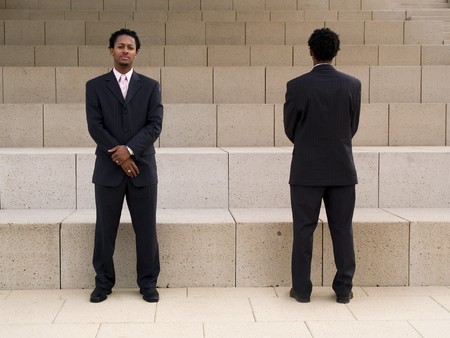 Front and back of a buisnessman on steps in front of a modern building.の写真素材
