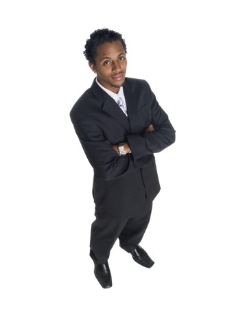 Isolated high angle studio shot of a businessman smiling at the camera with arms crossed.の写真素材