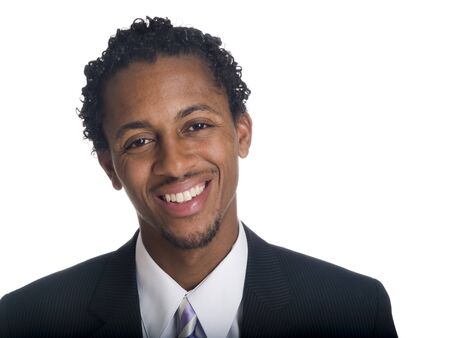 Isolated studio head shot of a relaxed businessman smiling at the camera.