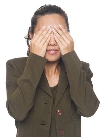 Isolated studio shot of a businesswoman in the See No Evil pose.の写真素材