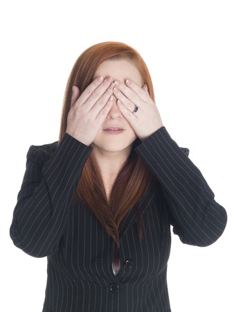 Isolated studio shot of a businesswoman in the See No Evil pose.の写真素材