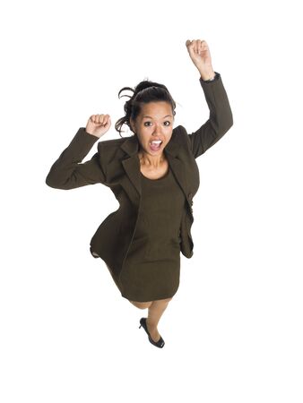 Isolated full length studio shot of a businesswoman jumping for joy.の写真素材
