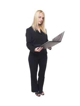 Isolated studio shot of a businesswoman reviewing notes in her notebook.の写真素材