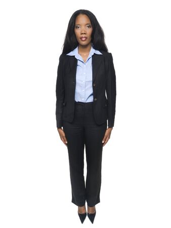 Isolated full length studio shot of a confident businesswoman standing and looking at the camera.の写真素材
