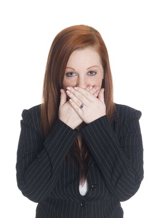 Isolated studio shot of a businesswoman in the Speak No Evil pose.の写真素材