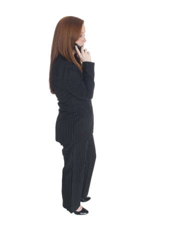 Isolated studio shot of a businesswoman chatting on her cell phone.の写真素材