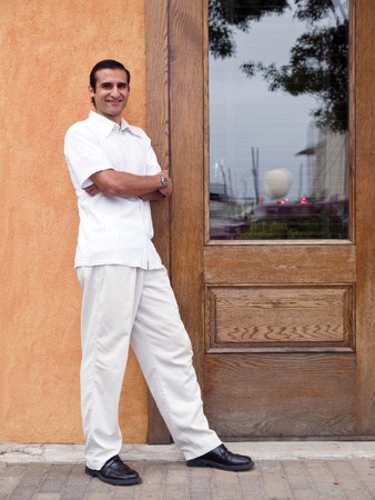 Casually dressed hispanic male standing and looking at the camera.の写真素材