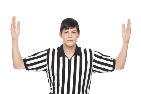 Isolated studio shot of a Caucasian man wearing a referee shirt and making a touchdown hand signal.